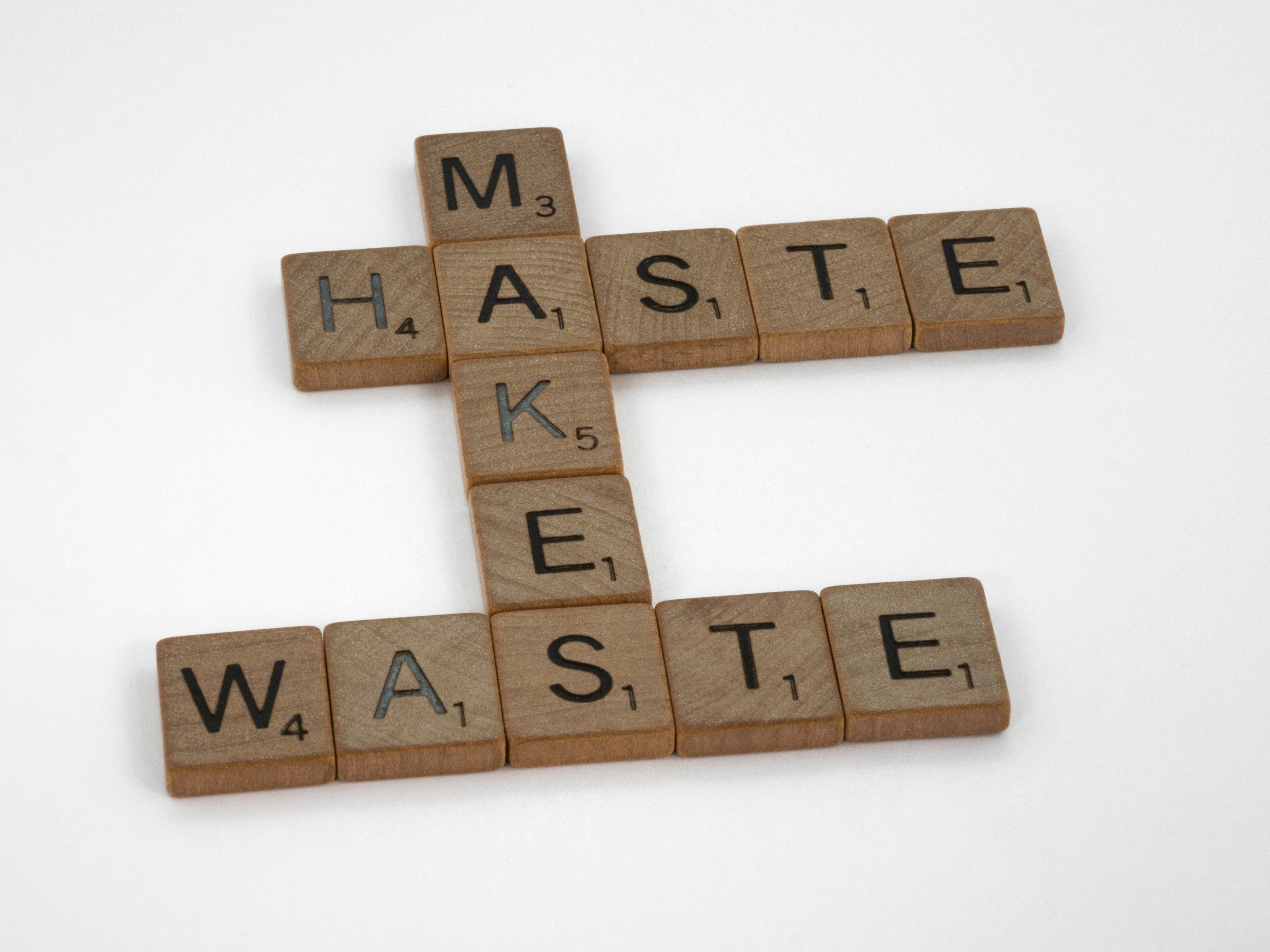 scrabble, scrabble pieces, lettering, letters, wood, scrabble tiles, white background, words, quote, letters, type, typography, design, layout, focus, bokeh, blur, photography, images, image, haste makes waste, slow down, consider, measure twice cut once, do not rush, focus, breathe, pause, think,